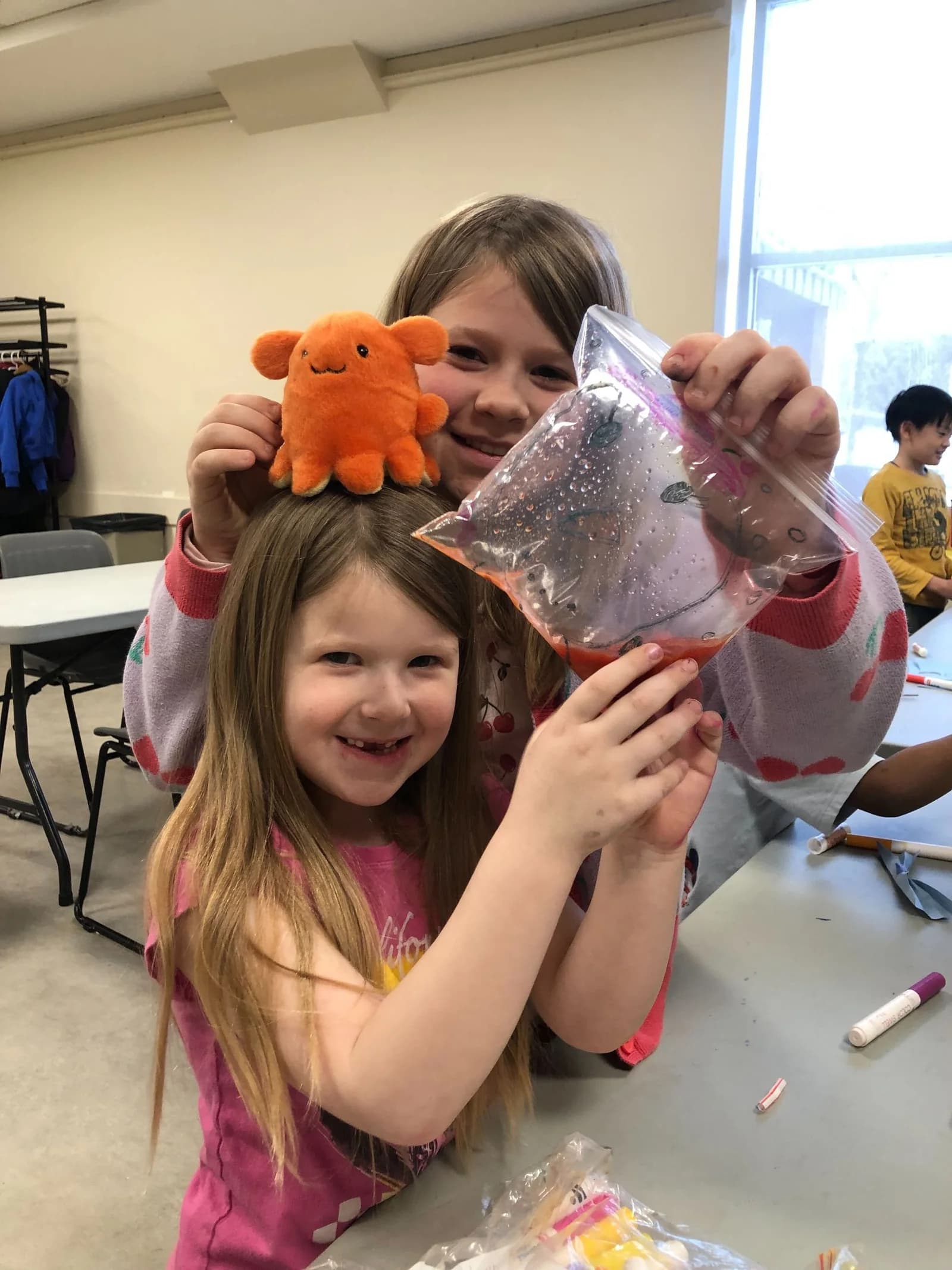 Two Laurus March Break campers showing their hands-on discovery activity